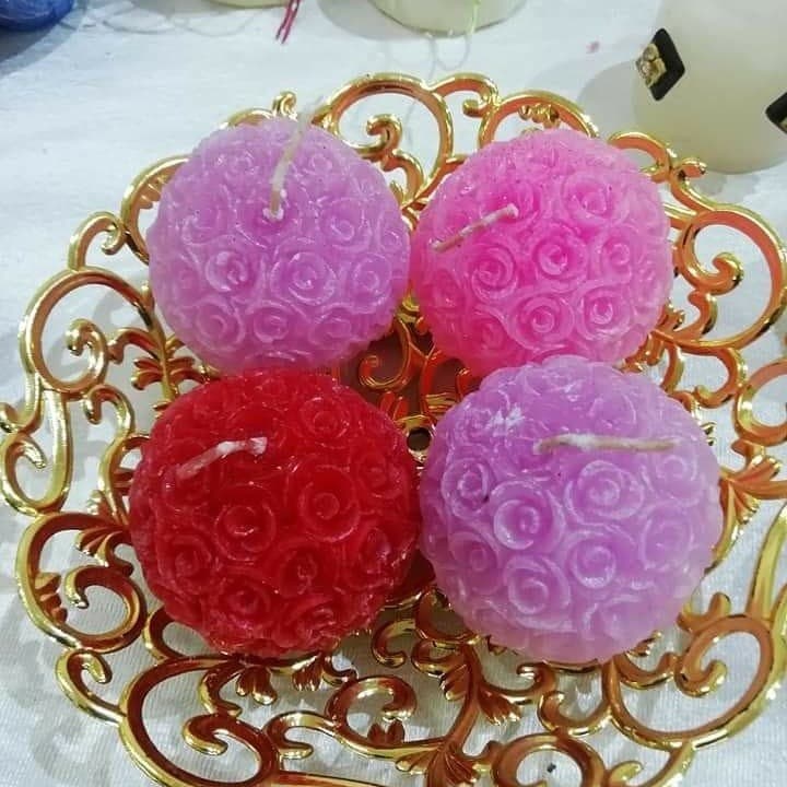 Pink, red and lavender rose ball candles in a decorative basket